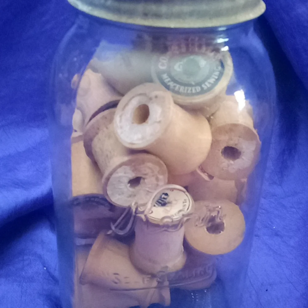 Vintage kerr Mason jar with 25 vintage wooden thread spools and a zinc l…
